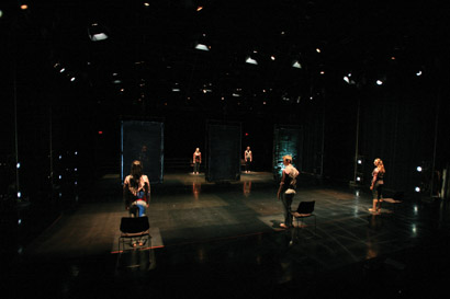 The performers are locked into repetitive motions and isolated rectangles of light