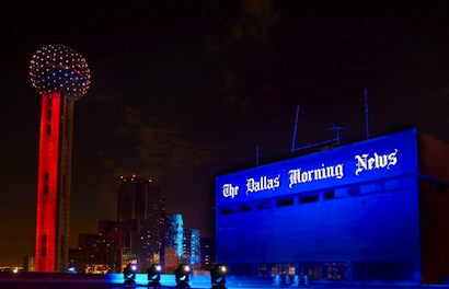 Syncrolite shines big color and beams on Reunion Tower and Dallas Morning News building.