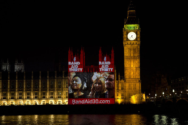 BandAid30 Gets Visual Boost with Large-Format Projection on British Houses of Parliament by London-Based The Projection Studio. Photo by Ross Ashton