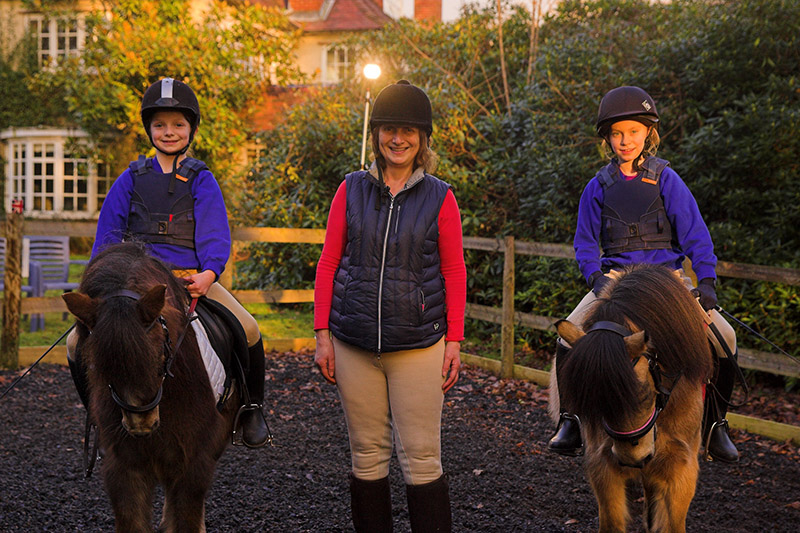 Olivier Brown Aged 8 on Brew (the smaller, darker pony) and Inca Lee aged 10 on Ruby – being taught by Andrea Brown© Louise Stickland