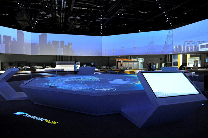The event production team designed a massive video octagon that encompassed close to 225 diagonal feet and flown 14 feet above the open concept interactive area, better known as the SAP Experience Zone.