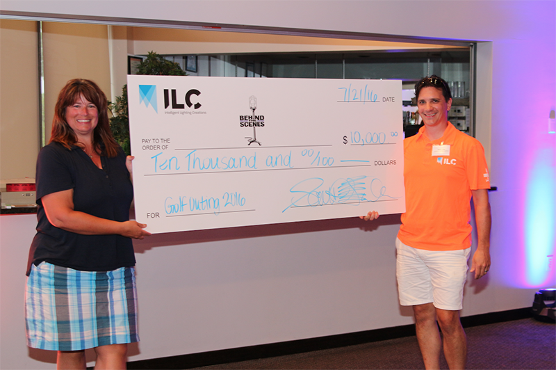 Laura Hoepker accepted the check totaling $10,000 on behalf of Behind the Scenes from Scott Falbe, CEO and Founder of ILC